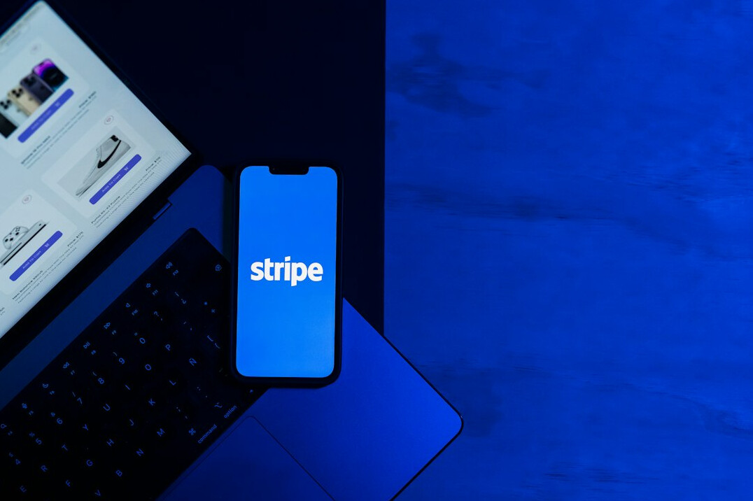 Laptop showing a simple form next to a notebook