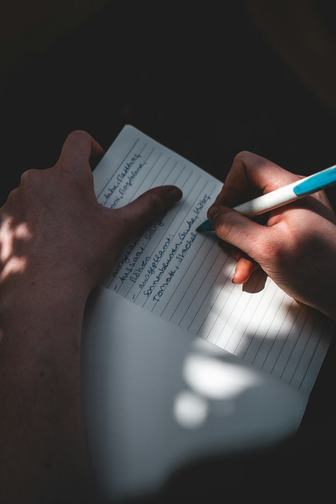 person writing budget notes